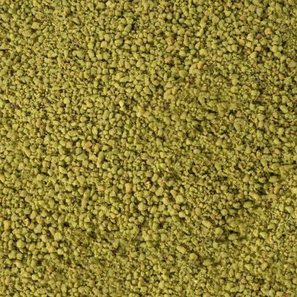 Gros plan sur une texture de poudre jaune-vert grossière et granuleuse recouvrant tout le cadre.